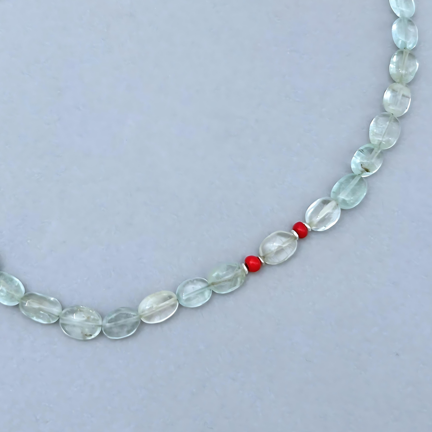 The Le BijouBijou Gemma Necklace is a delicate beauty. Made with oval-shaped pale blue Aquamarines and a touch of Coral.