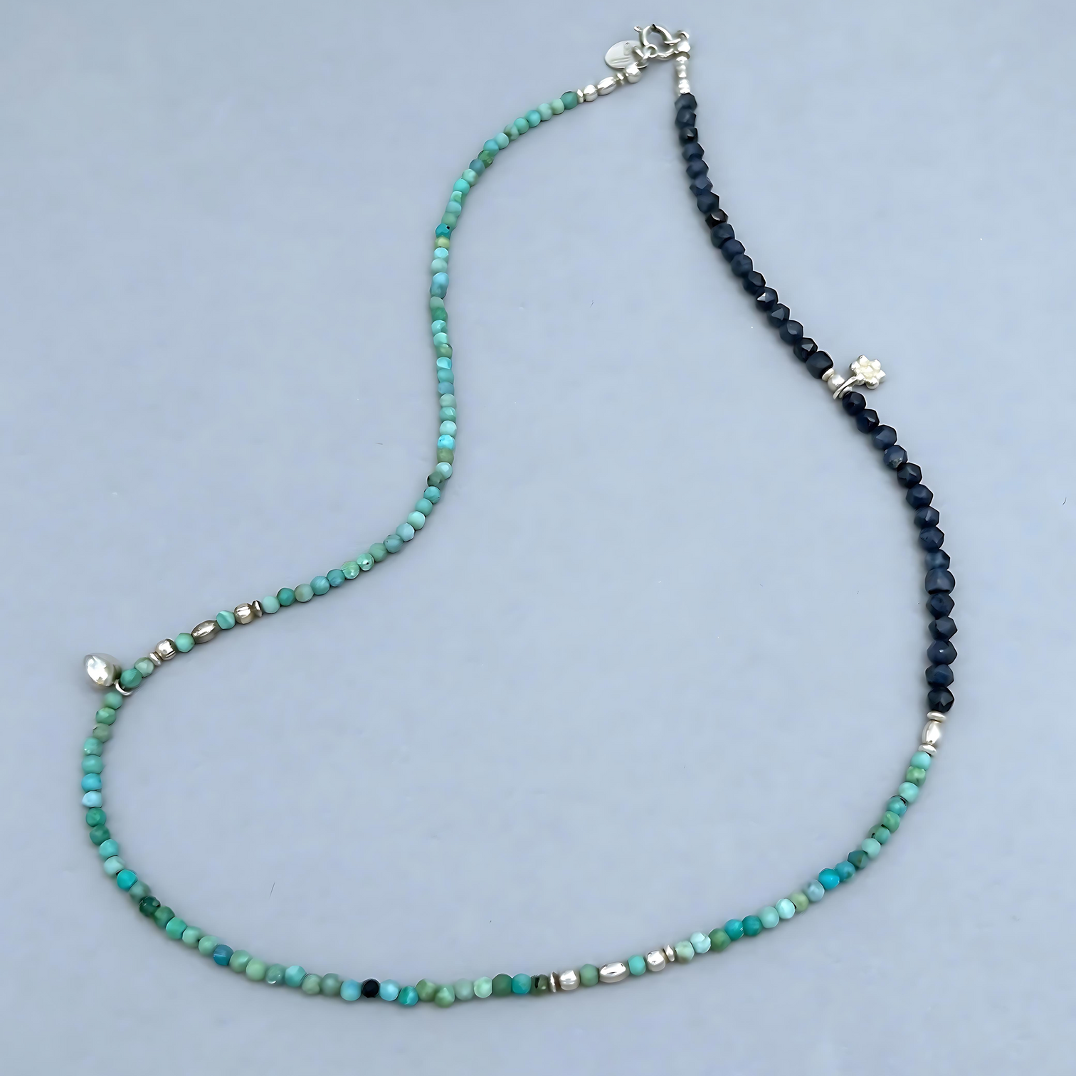This Le BijouBijou Joy Necklace is pure joy. The soft-toned faceted Opals combined with Sapphires, the two small charms and Sterling Silver Elements set this Necklace apart. 