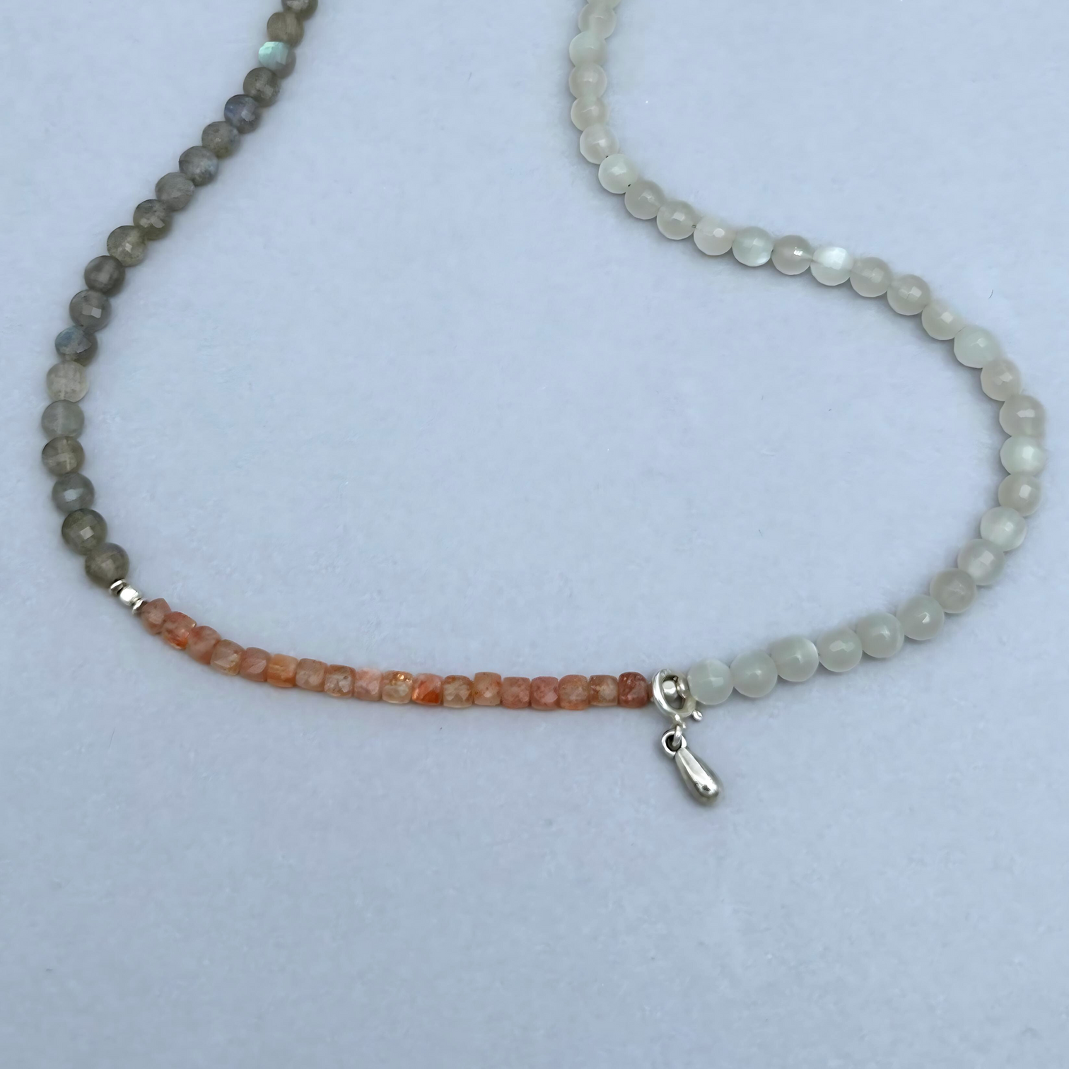 The soft feminine energy of Moonstones combined with the joyful vibes of Sunstone and the motivating powers of Labradorite gives this Ellie necklace a unique aura.