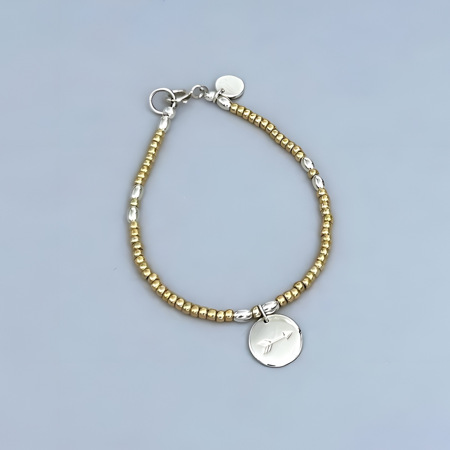 The LeBijouBijou Streak of Gold  Bracelet made with yellow, sterling silver, charm with an arrow.. 