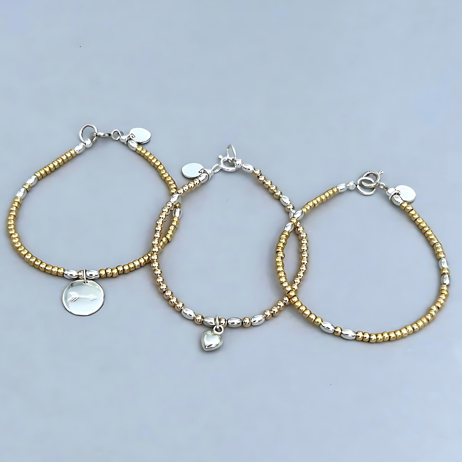 The LeBijouBijou Streak of Gold Trio Bracelets made with yellow, pink and sterling silver. 