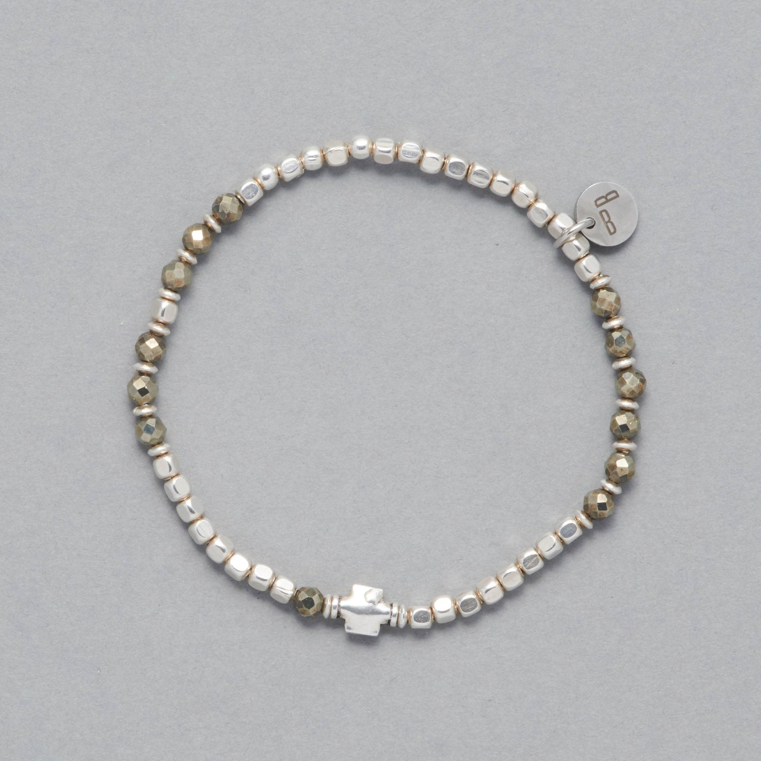 The Ceres Bracelet is strung with faceted Pyrite beads, octagonal sterling silver beads and as a center piece a sterling silver element