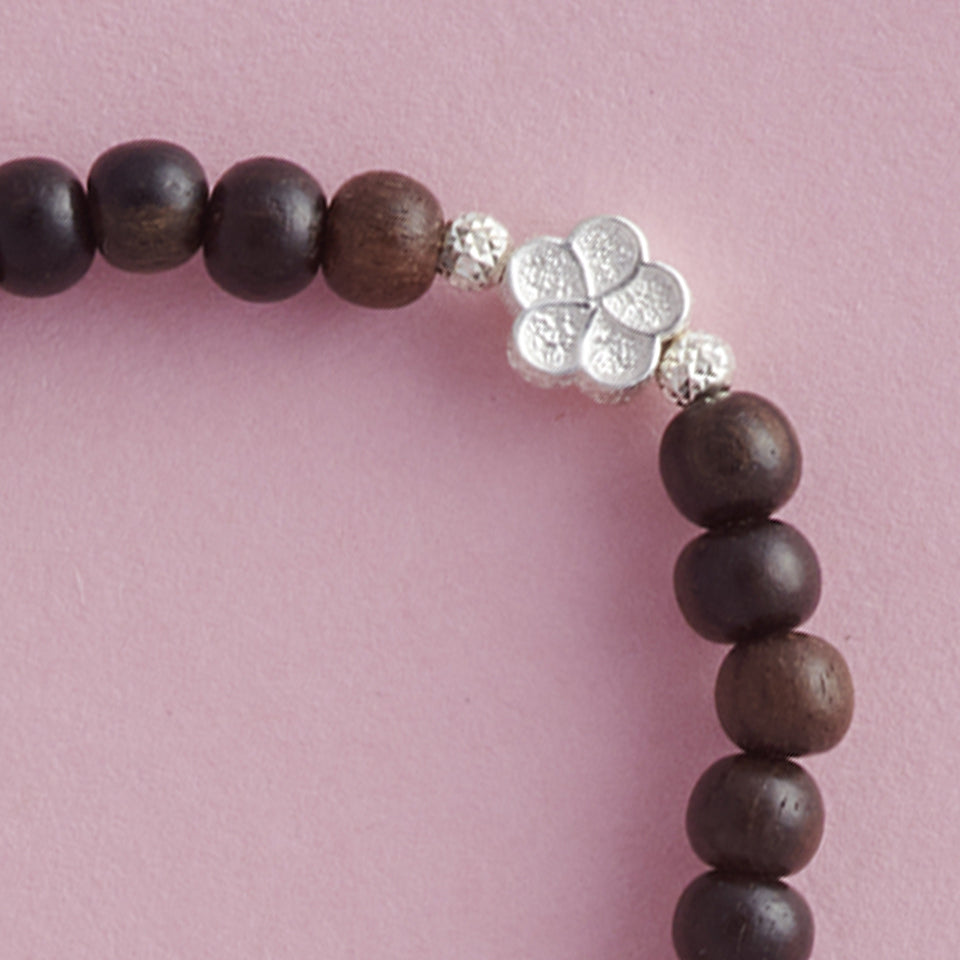 Close-up of My Special Flowers Girls Bracelet, made with Ebony Wood and cute Silver Flowers.