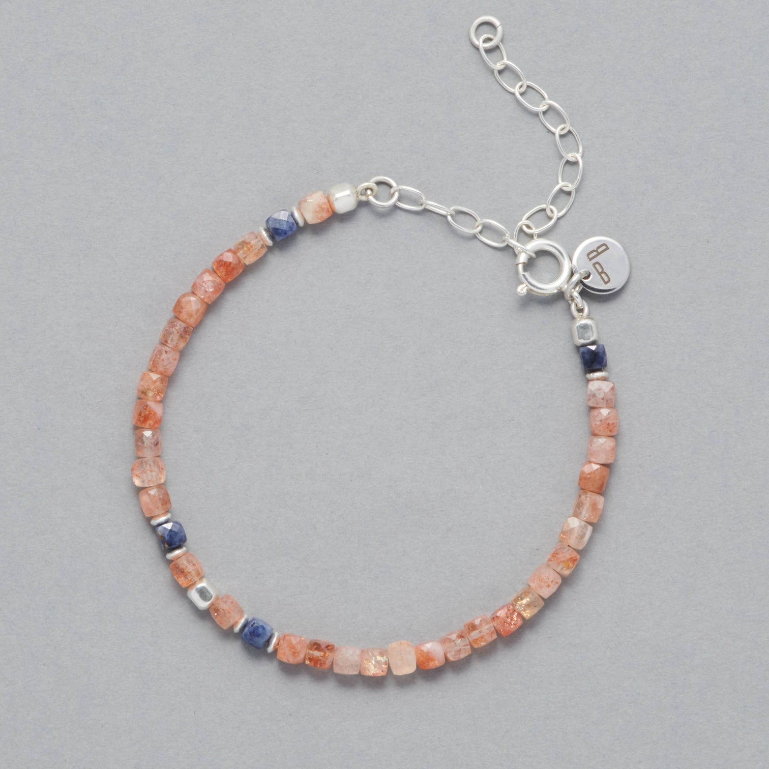 Product shot of the Ginger Anklet made with square faceted Sunstones, faceted square Sapphires and Sterling Silver Elements. 