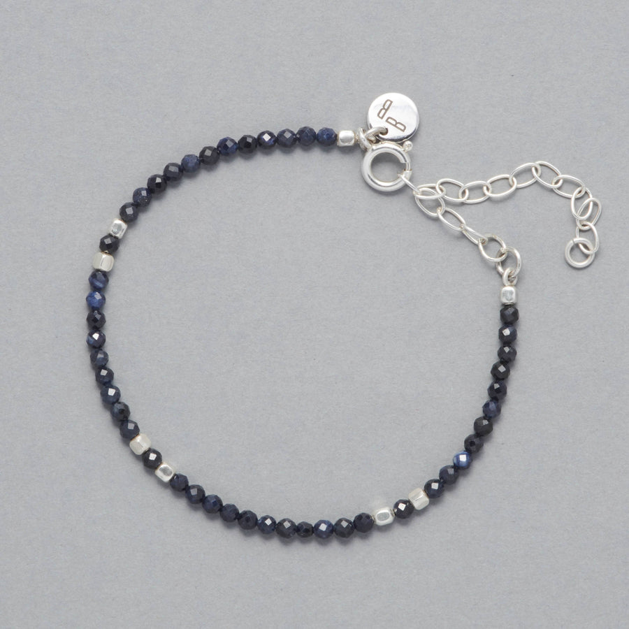 Product shot of the Indigo Anklet made with faceted Sapphires and square shaped Sterling Silver Beads. 
