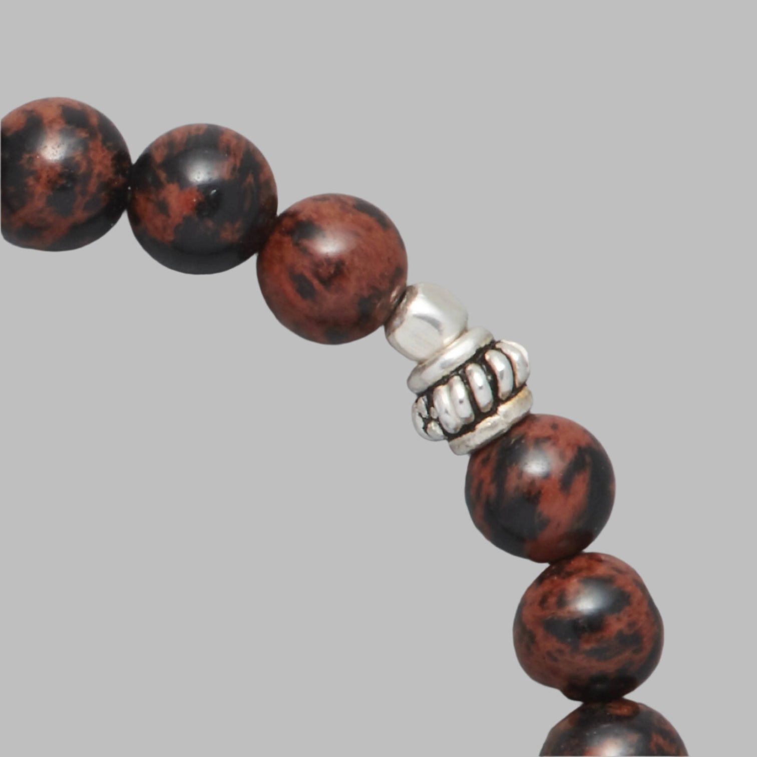 Detail shot of the Kane Men Beaded Bracelet made with Mahogany Obsidian and Sterling Silver Elements.