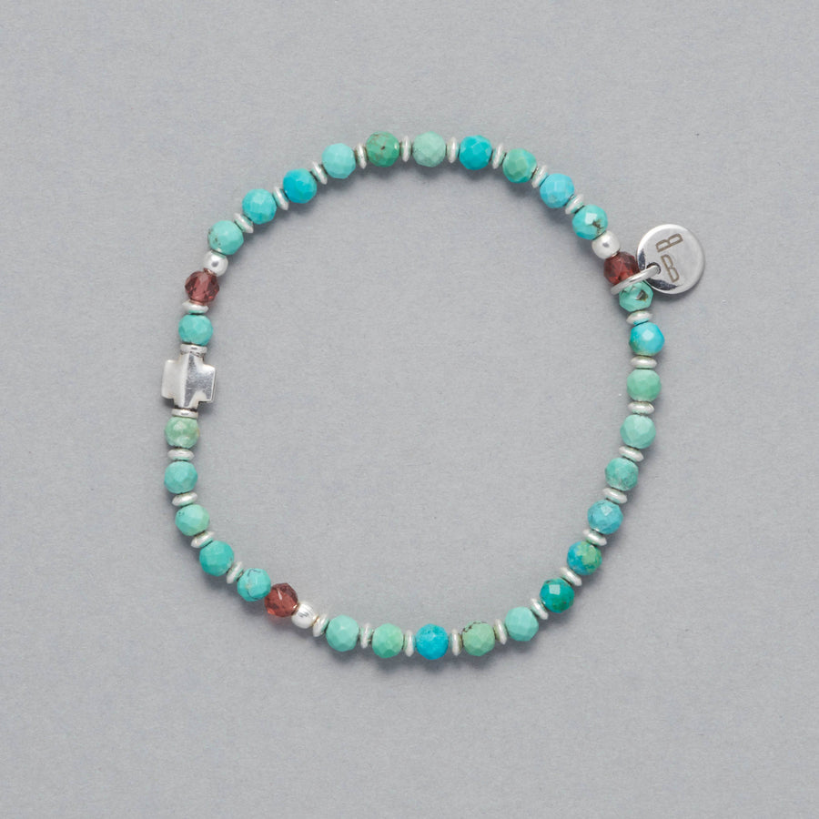 Product shot of the Kya Bracelet made with faceted Turquoise, faceted Garnet and Sterling Silver Elements. 