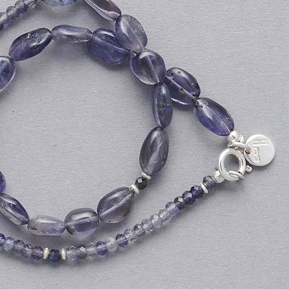 Close-Up of the LE BIJOUBIJOU MIRA Double Wrap Bracelet made with oval-shaped Iolite and faceted Iolite. 