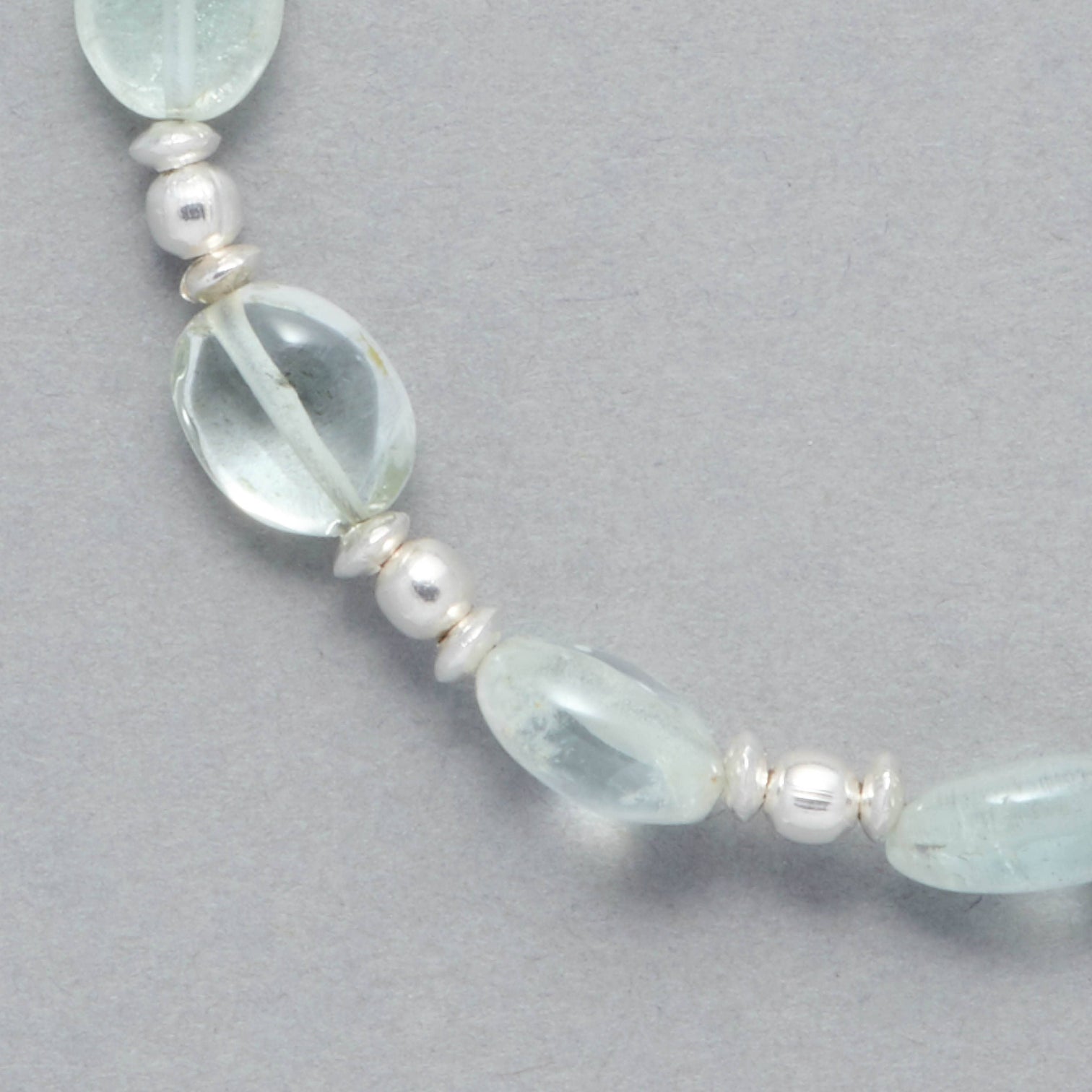 Detail shot of the Zoe Bracelet made with oval-shaped Aquamarine and Sterling Silver elements.
