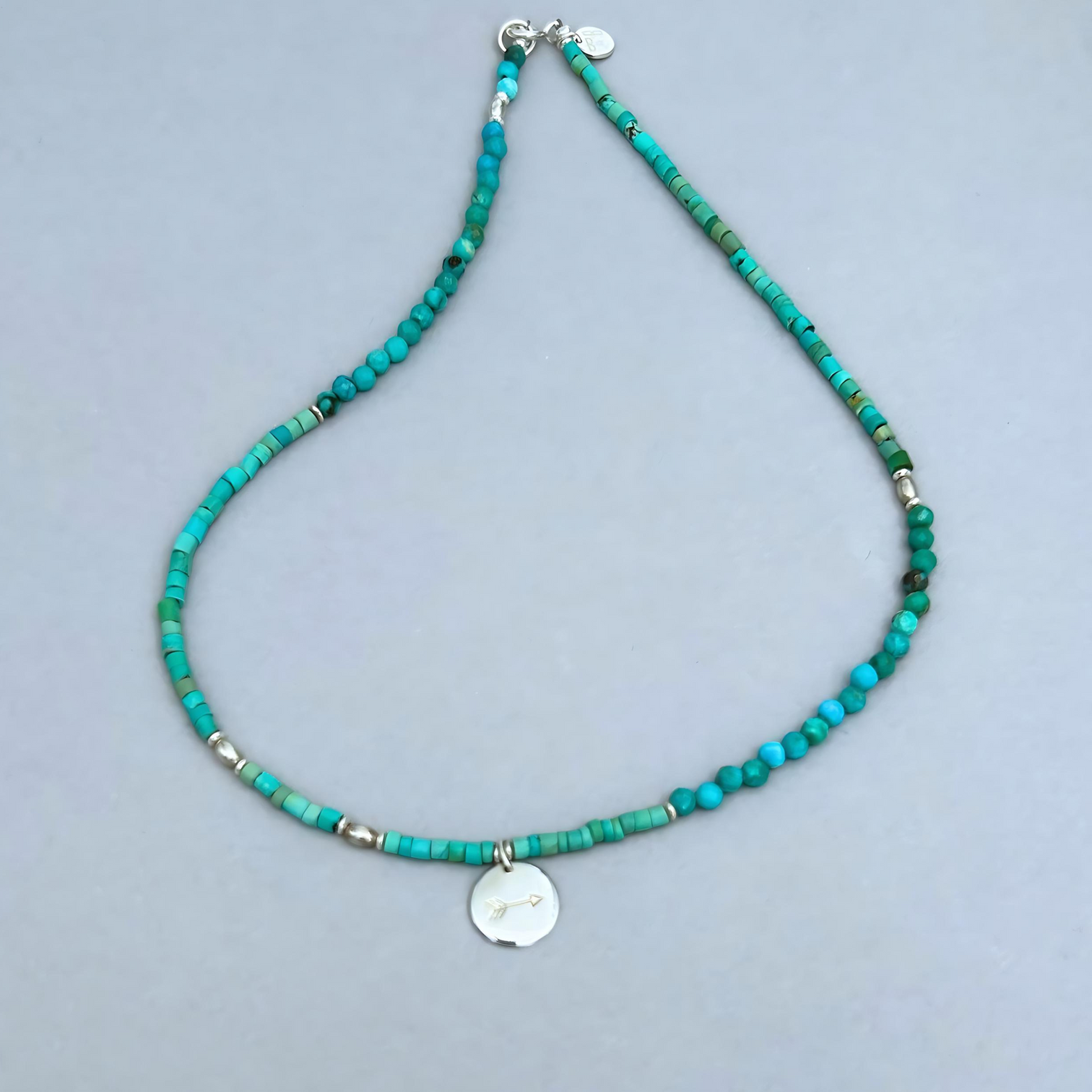 Free Spirit Necklace from Le BijouBIjou made with turquoise rondelles and a silver charm with an arrow.