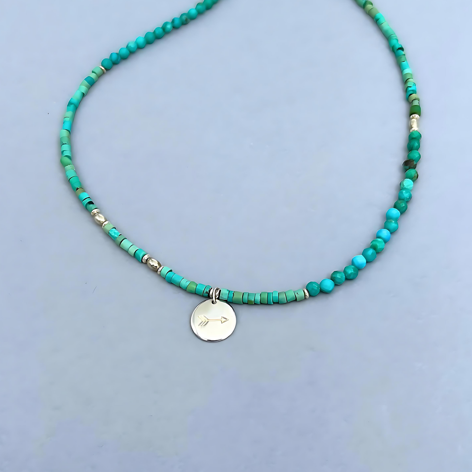 Free Spirit Necklace from Le BijouBIjou made with turquoise rondelles and a silver charm with an arrow. Detail shot