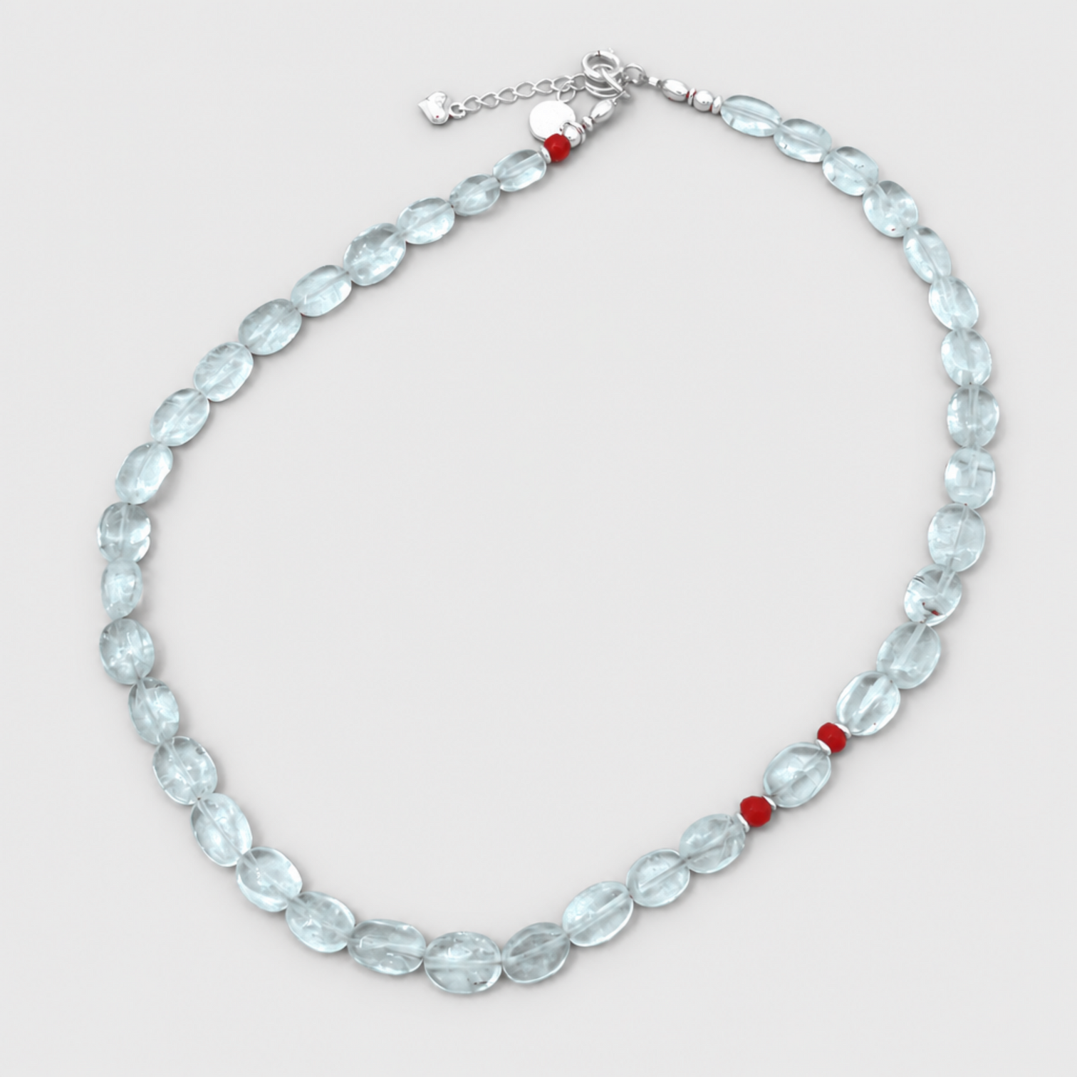 GEMMA necklace with oval aquamarine beads, red coral accents and silver clasp on a neutral light-grey background.