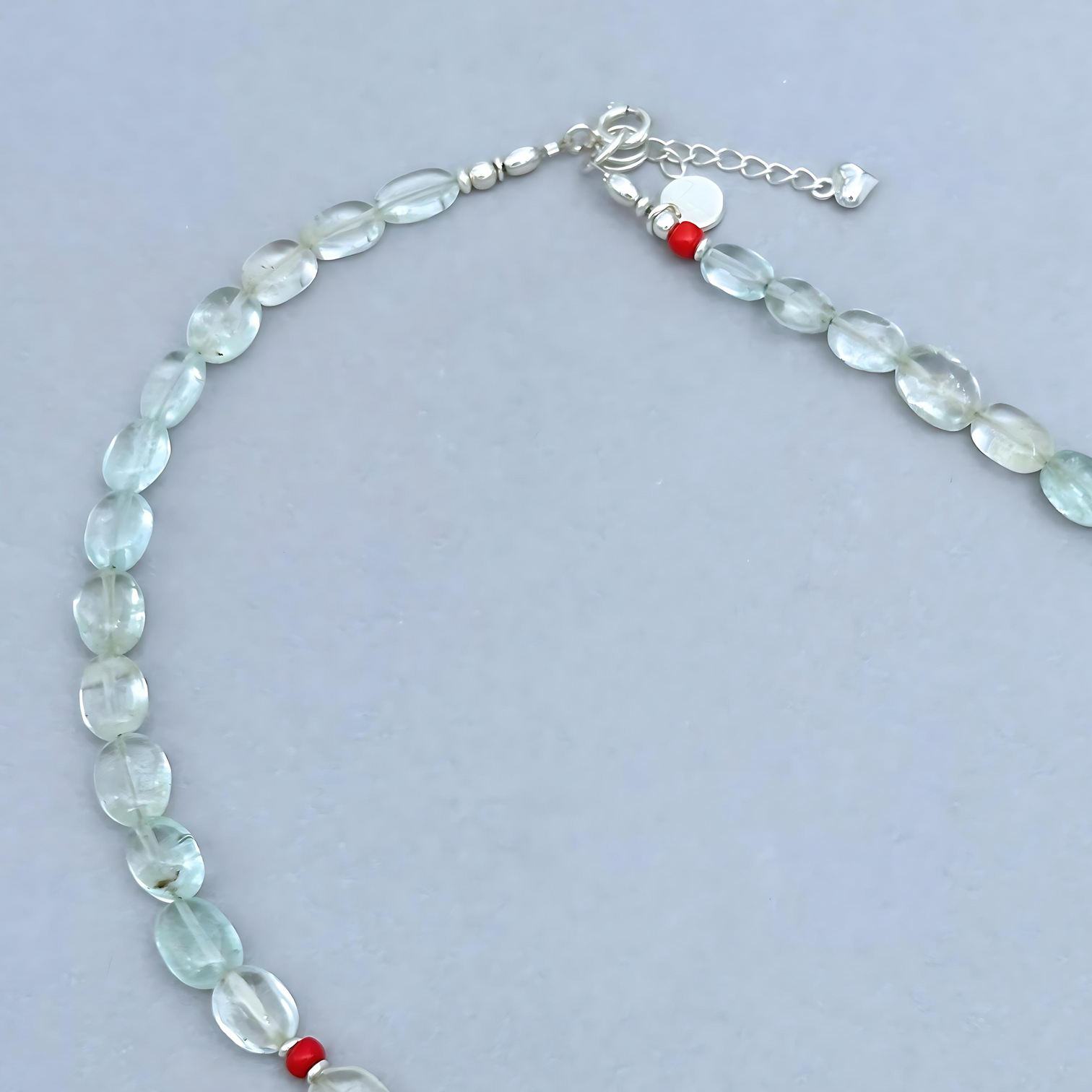 The Le BijouBijou Gemma Necklace is a delicate beauty. Made with oval-shaped pale blue Aquamarines and a touch of Coral.