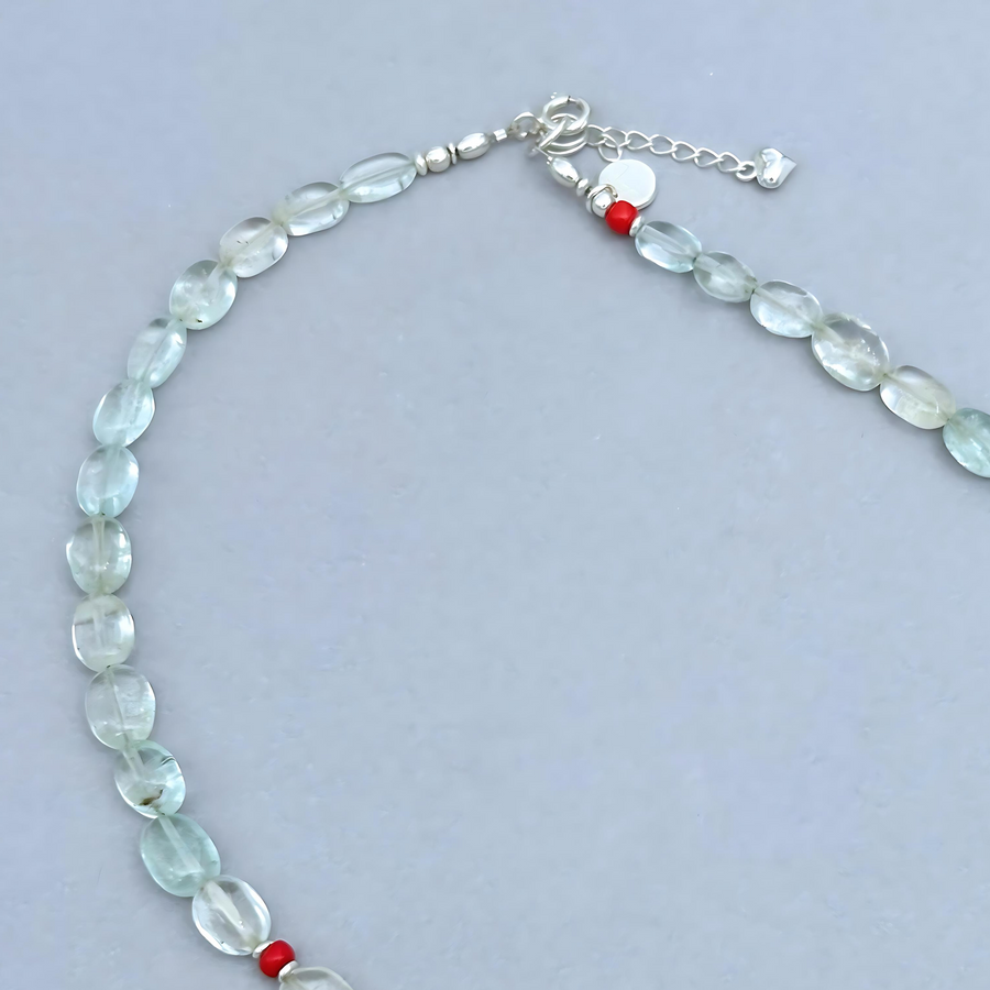 The Le BijouBijou Gemma Necklace is a delicate beauty. Made with oval-shaped pale blue Aquamarines and a touch of Coral.