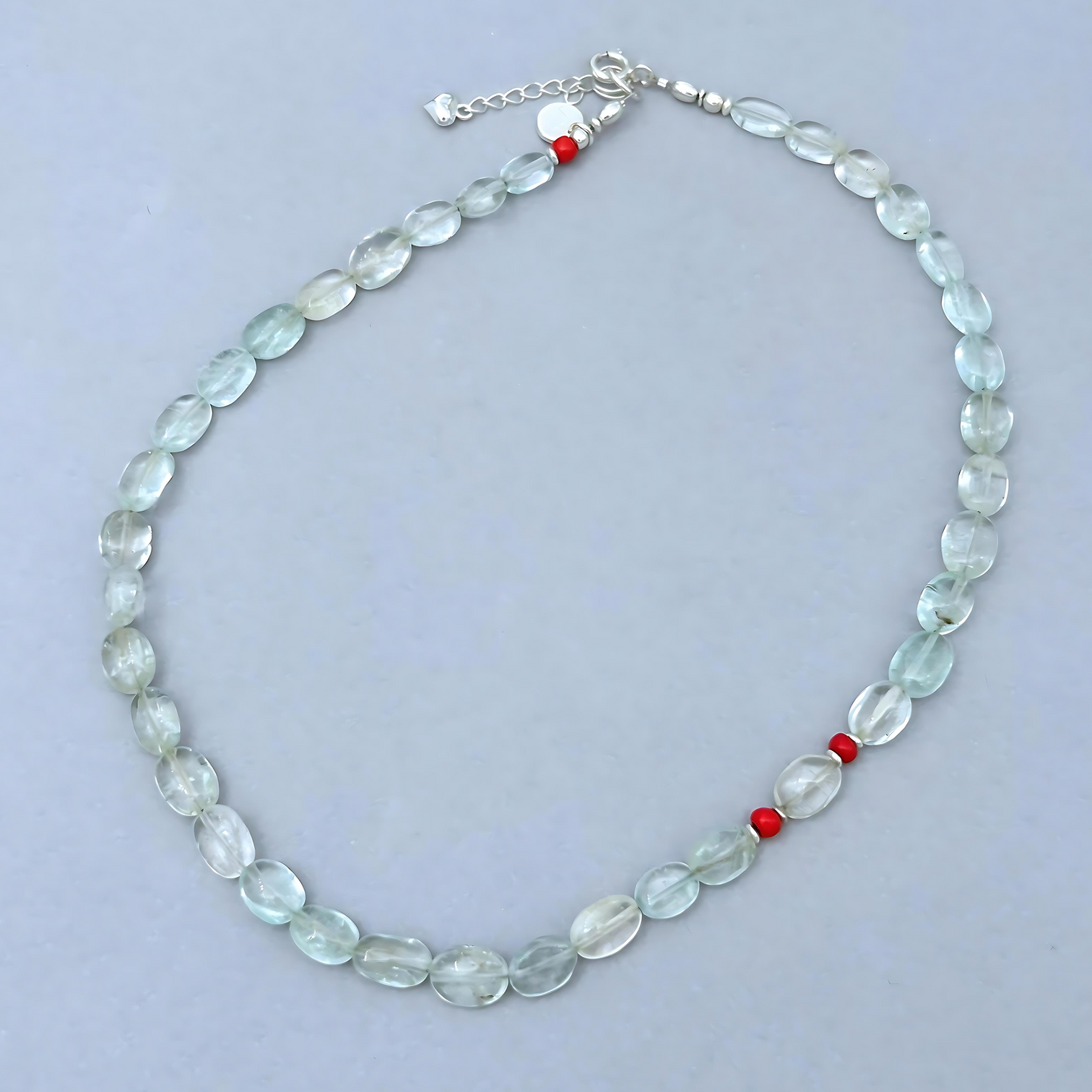 The Le BijouBijou Gemma Necklace is a delicate beauty. Made with oval-shaped pale blue Aquamarines and a touch of Coral.