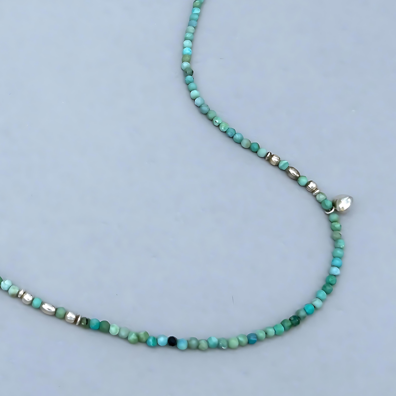 This Le BijouBijou Joy Necklace is pure joy. The soft-toned faceted Opals combined with Sapphires, the two small charms and Sterling Silver Elements set this Necklace apart. 
