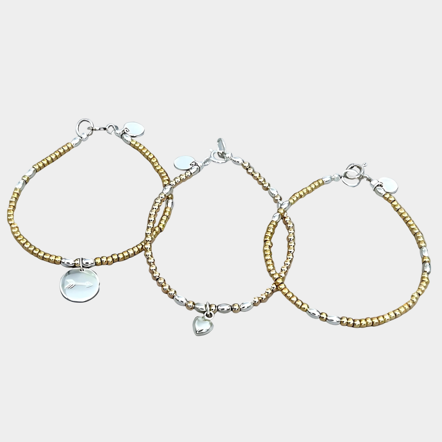 The LeBijouBijou Streak of Gold Trio Bracelets made with yellow, pink and sterling silver. 