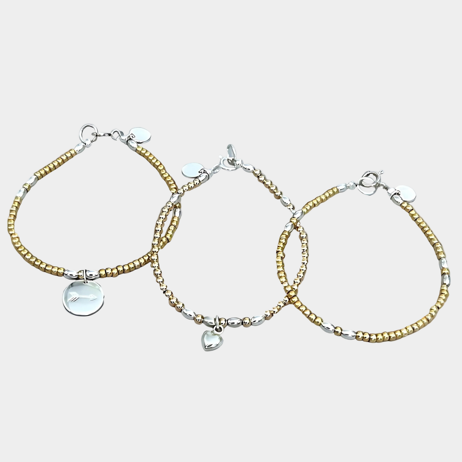 The LeBijouBijou Streak of Gold Trio Bracelets made with yellow, pink and sterling silver. 