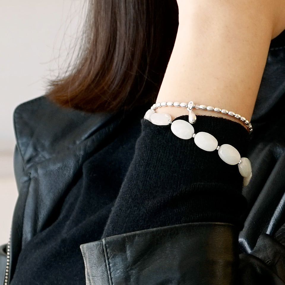 Close-up of Model wearing the LE BIJOUBIJOU ALINA Double Wrap Bracelet. This bracelet is made with faceted Olive-Shaped Moonstone and Sterling Silver. 