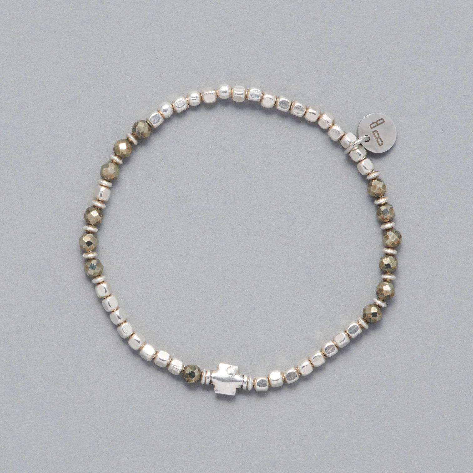 The Ceres Bracelet is strung with faceted Pyrite beads, octagonal sterling silver beads and as a center piece a sterling silver element 