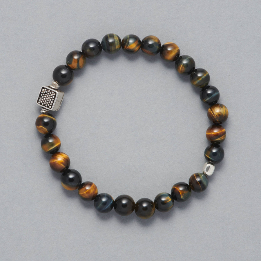 The Chey Bracelet is a beaded men bracelet made with Blue Tiger Eye. As a centerpiece there is a beautiful Sterling Silver Element.
