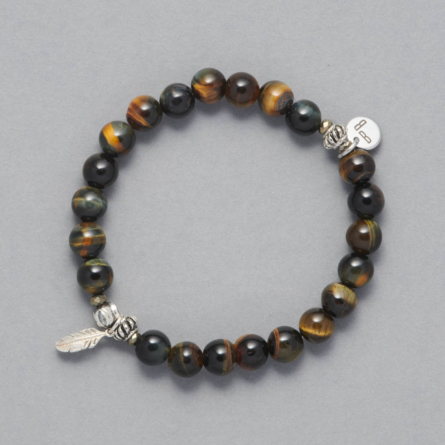 Product Shot of the Cheyenne bracelet made with Blue Tiger Eye, Sterling Silver Elements and a Sterling Silver feather charm. 