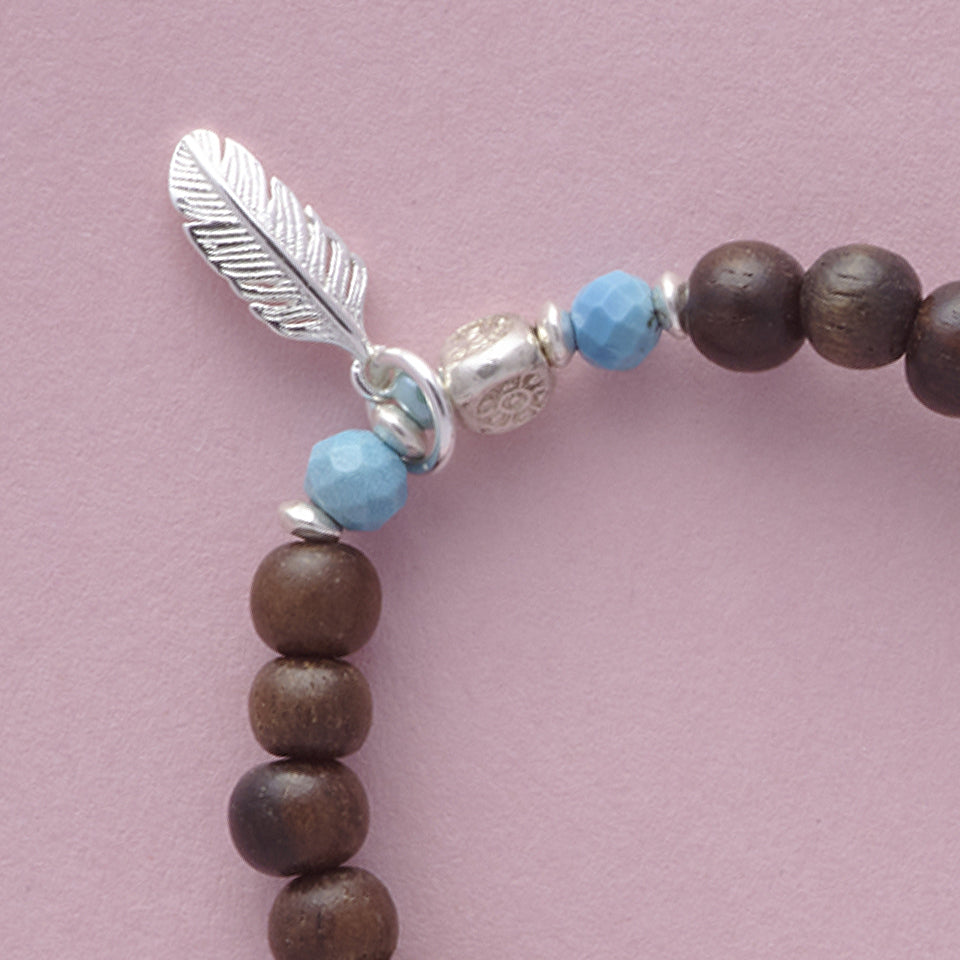 Close-up of the Le BijouBijou - My Little Feather Bracelet - made with Ebomy, Turquois and sterling silver.