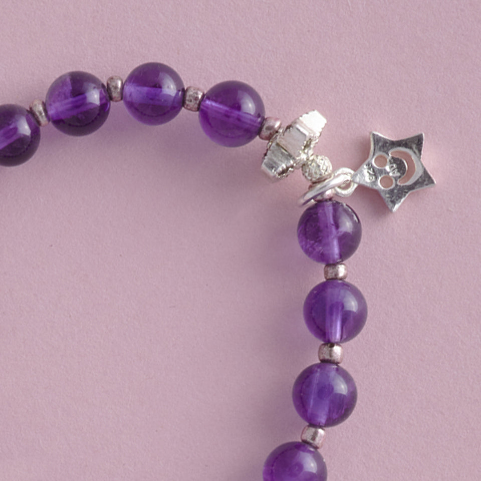 Close-up of the Lucky Star Le BijouBijou Bracelet for girls. Made with round Amethyst and Sterling Silver stars.