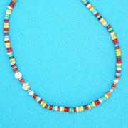 Close-up of the Linda Necklace made with multicoloured Howlite Discs and a touch of Coral and a Freshwater Pearl. 