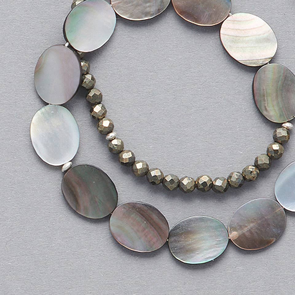 Product close-up of the ELEA Double Wrap Bracelet made with Mother of Pearl and Pyrite. 