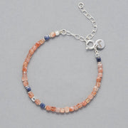 Product shot of the Ginger Anklet made with square faceted Sunstones, faceted square Sapphires and Sterling Silver Elements. 