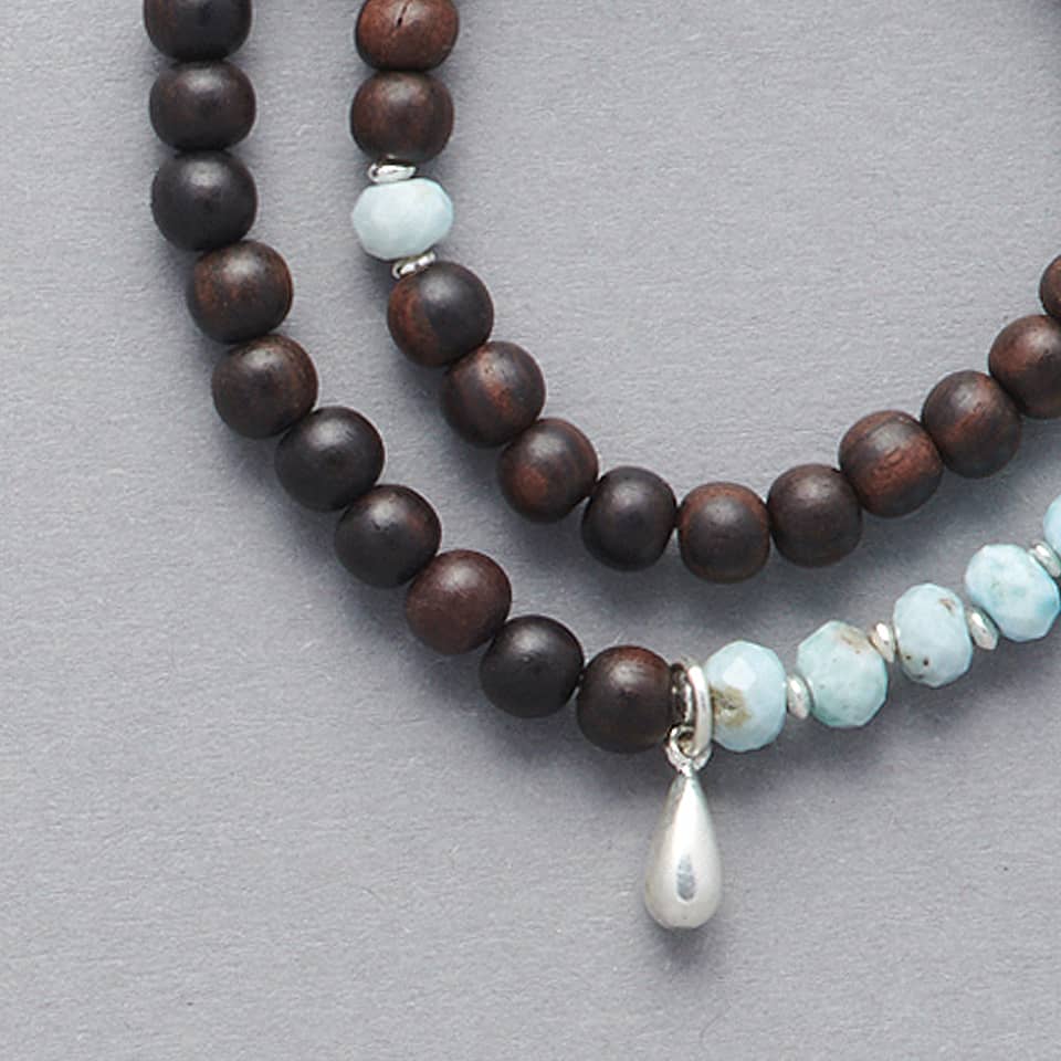 Close-up of the KAIA Double Wrap Bracelet made with Ebony Wood, Larimar and a touch of Sterling Silver