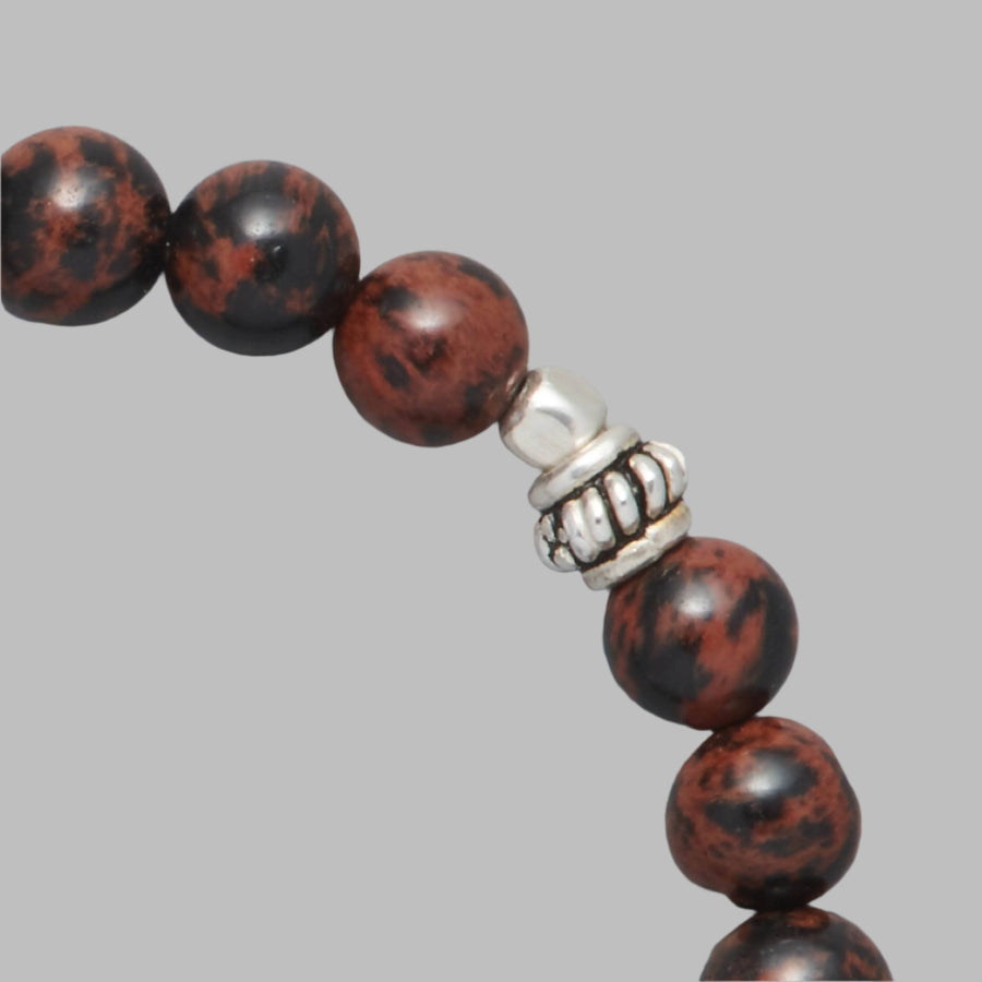 Detail shot of the Kane Men Beaded Bracelet made with Mahogany Obsidian and Sterling Silver Elements. 