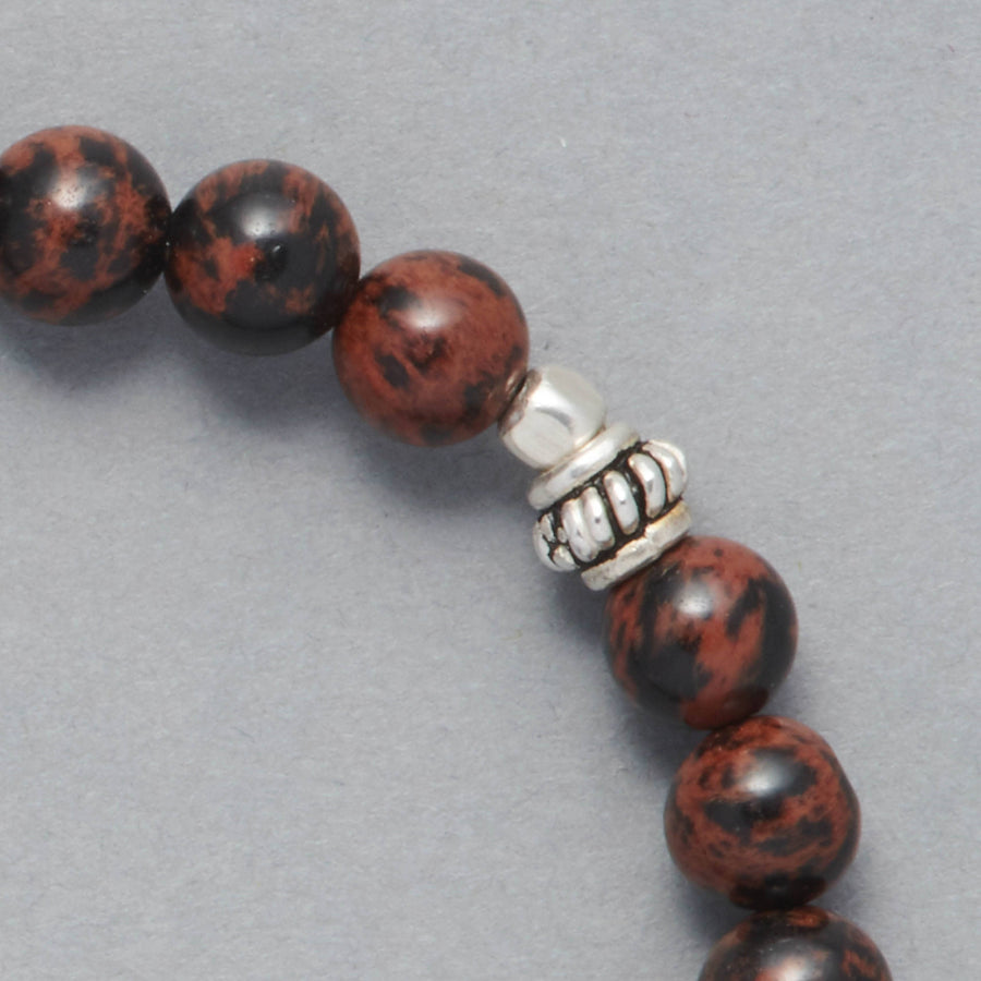 Detail shot of the Kane Men Beaded Bracelet made with Mahogany Obsidian and Sterling Silver Elements. 