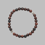 Product shot of the Kane Men Beaded Bracelet made with Mahogany Obsidian and Sterling Silver Elements. 