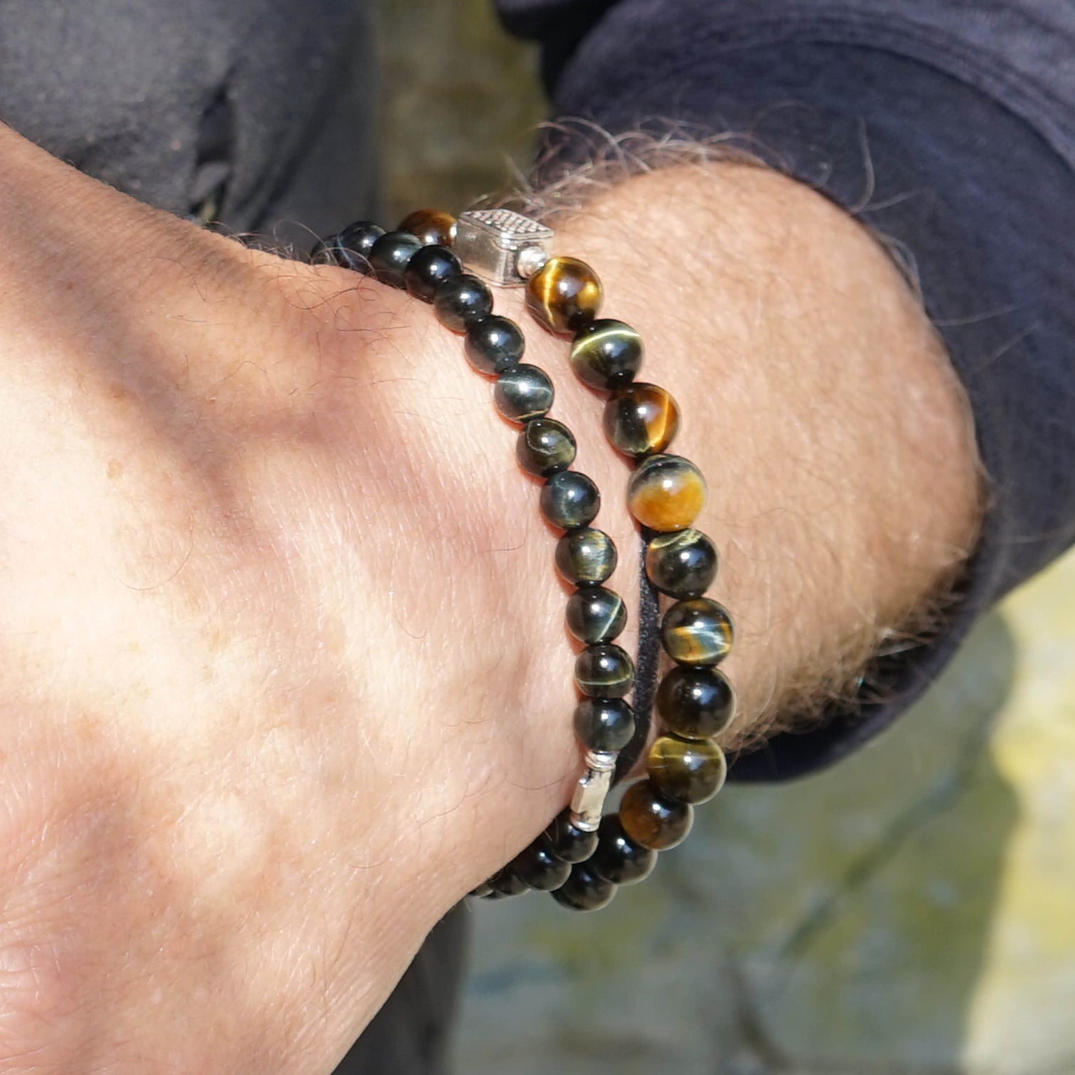 Male Model wearing the Liam and the Chey Men Beaded Bracelet made with Falcon Eye called as well Blue Tiger Eye and Sterling Silver. 