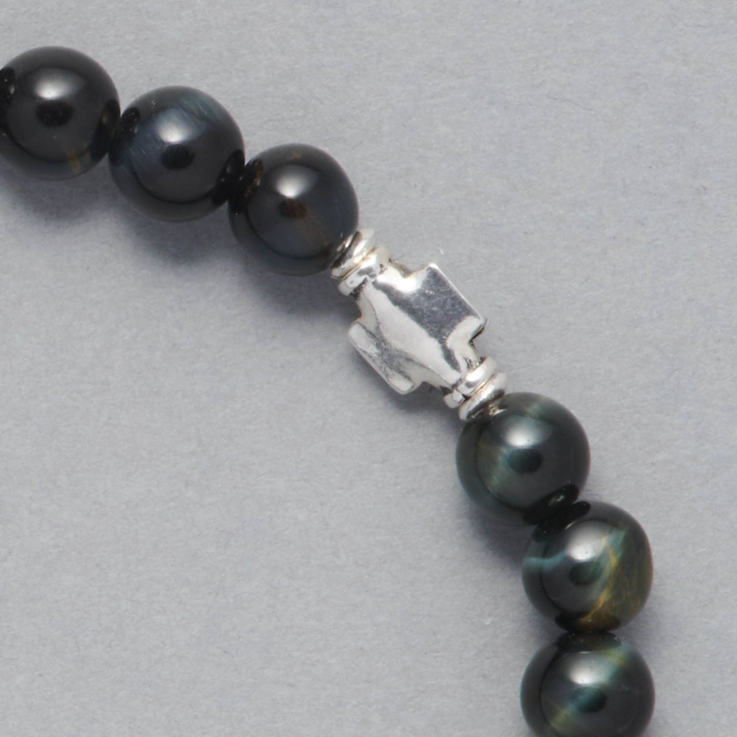 Detail shot of the Liam Men Beaded Bracelet made with Falcon Eye and Sterling Silver Element. 
