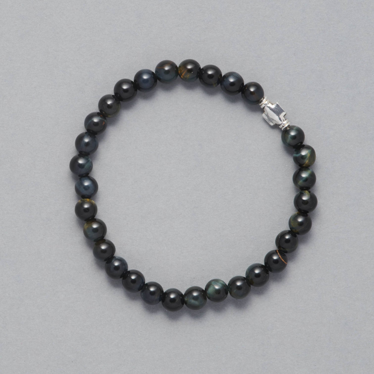 Product shot of the Liam men Beaded Bracelet made with Falcon Eye and Sterling Silver Elements. 