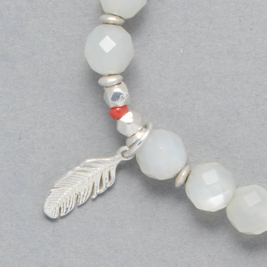 Detail Shot of the Luna Bracelet made with Moonstone, Sterling Silver Elements and a Charm representing a feather. 