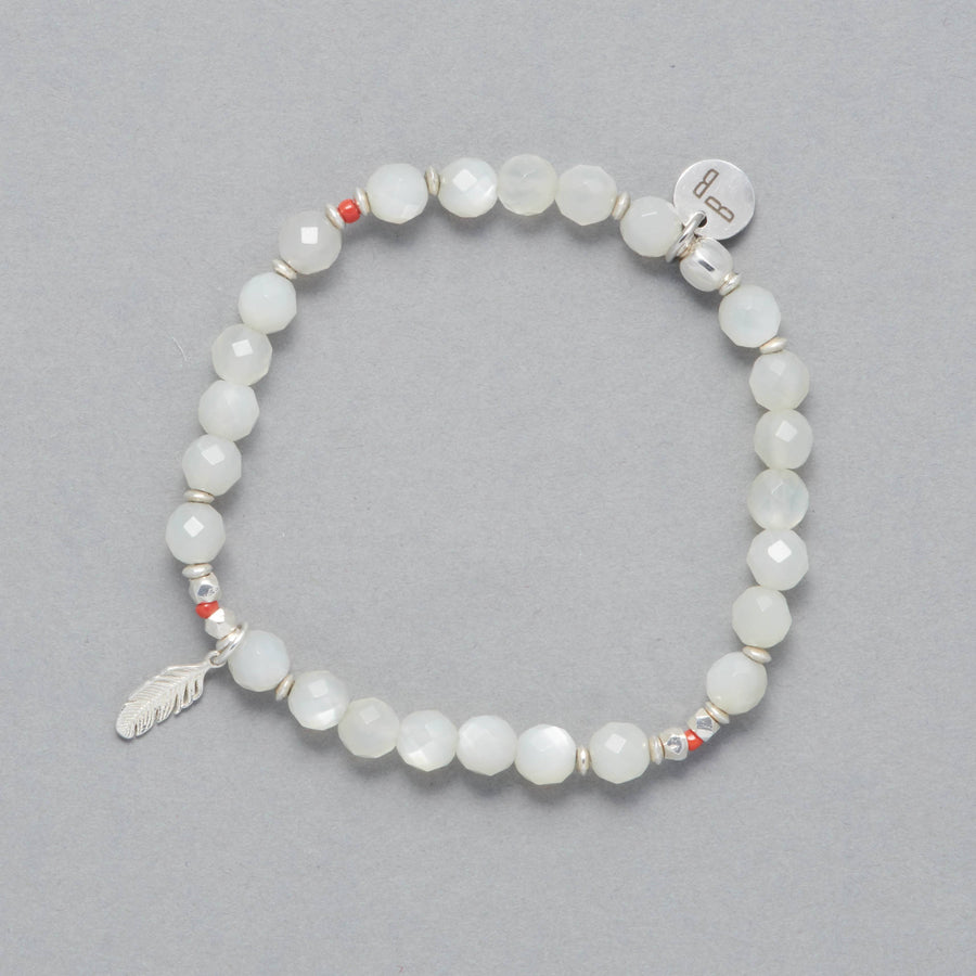 Product Shot of the Luna Bracelet made with Moonstone, Sterling Silver Elements and a Charm representing a feather. 