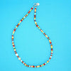 Product Shot of the Linda Necklace made with multicoloured Howlite Discs and a touch of Coral and a Freshwater Pearl. 
