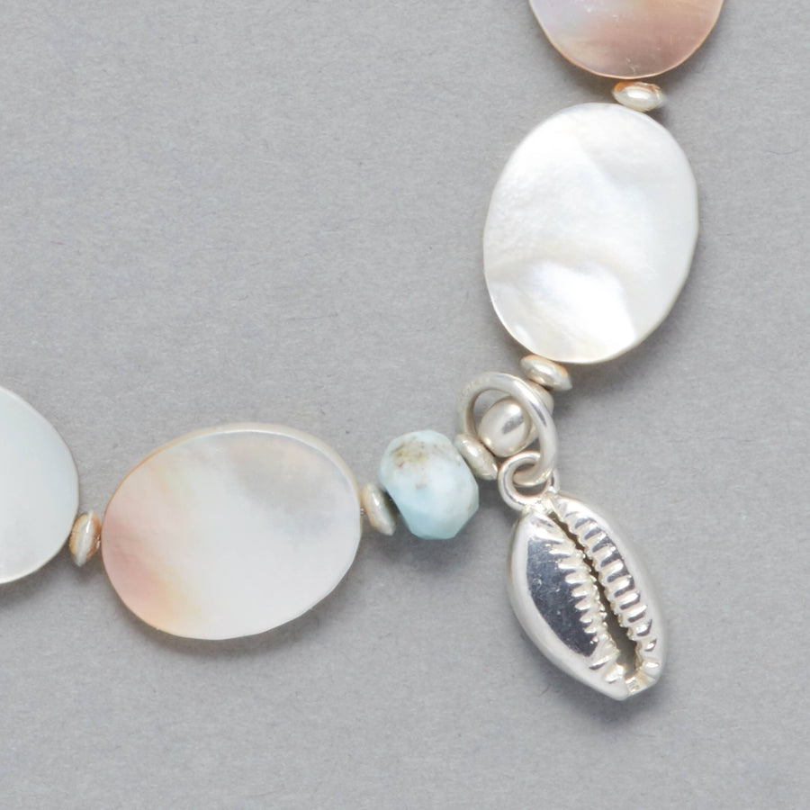 Detail shot of the MARILLA Bracelet made with Larimar, Mother of Pearl, Sterling Sliver elements and a Seashell Charm. 