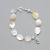 Product shot of the MARILLA Bracelet made with Larimar, Mother of Pearl, Sterling Sliver elements and a Seashell Charm. 