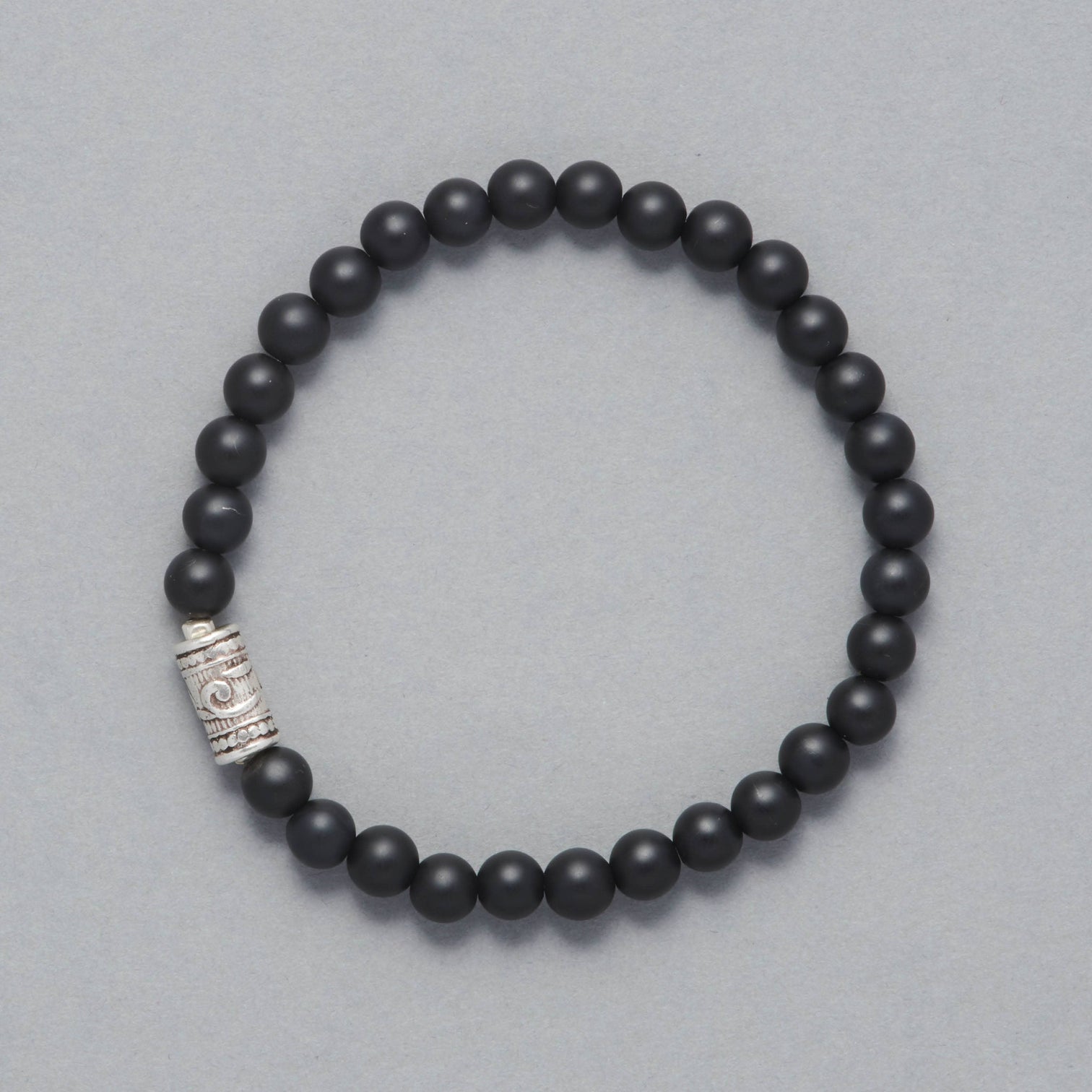 Product shot of the Maxim Men Beaded Bracelet made with Mat Black Onyx and a Sterling Silver Element.
