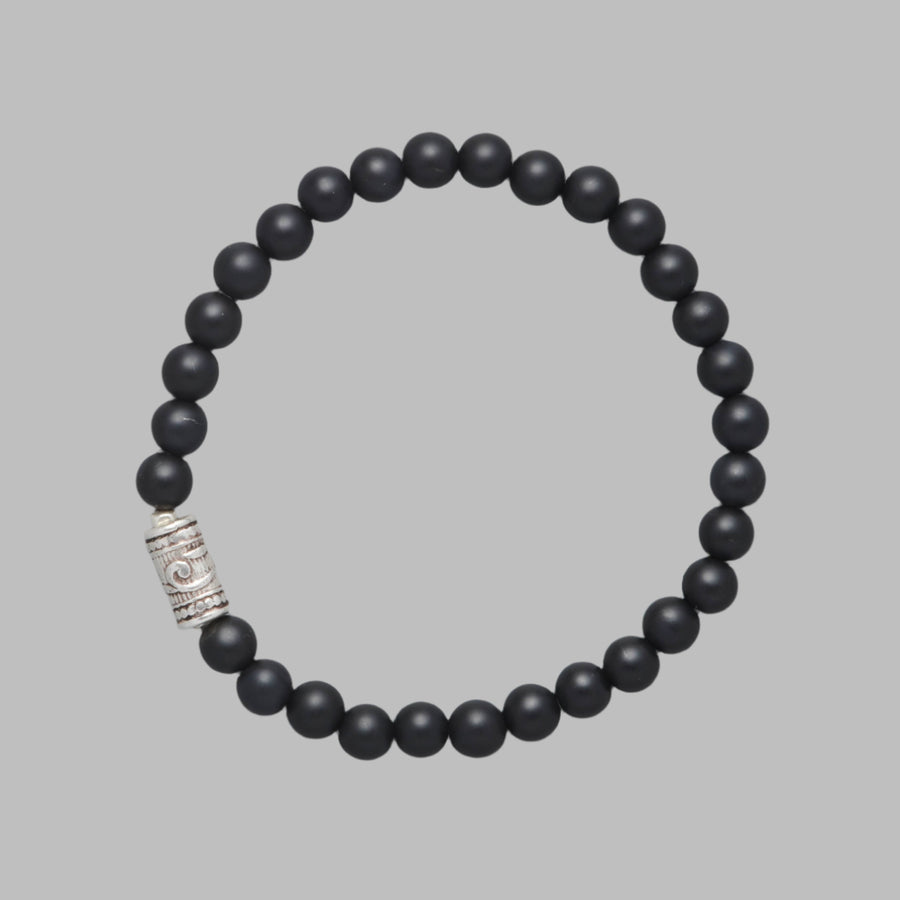 Product shot of the Maxim Men Beaded Bracelet made with Mat Black Onyx and a Sterling Silver Element.