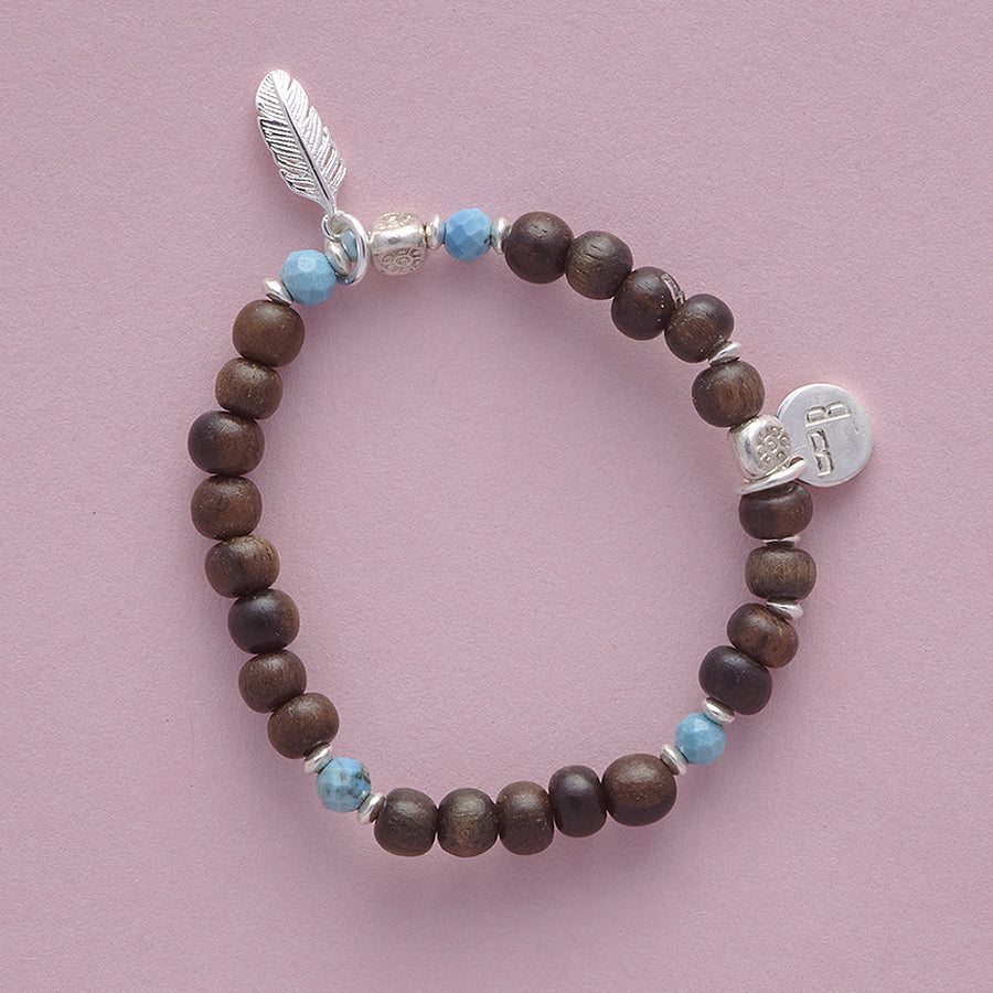 Product shot of the Le BijouBijou - My Little Feather Bracelet - made with Ebomy, Turquois and sterling silver.