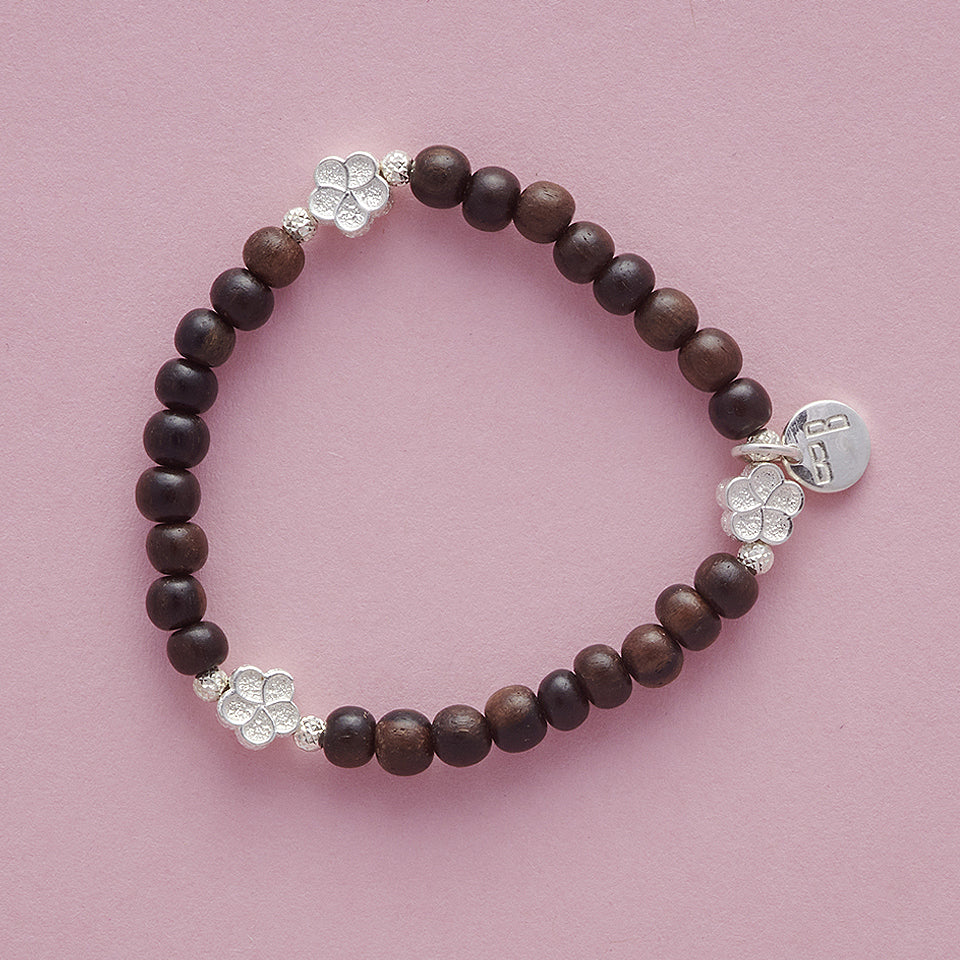 Product shot of My Special Flowers Girls Bracelet, made with Ebony Wood and cute Silver Flowers.