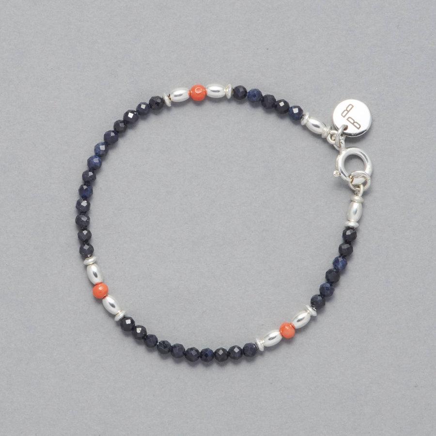 Product shot of the Sky Bracelet made with Sapphire, Coral and Sterling Silver elements.
