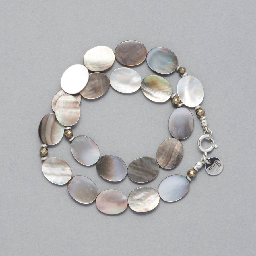Product shot of the Stella Bracelet made with Mother of Pearl, Pyrite and Sterling Silver Elements. 