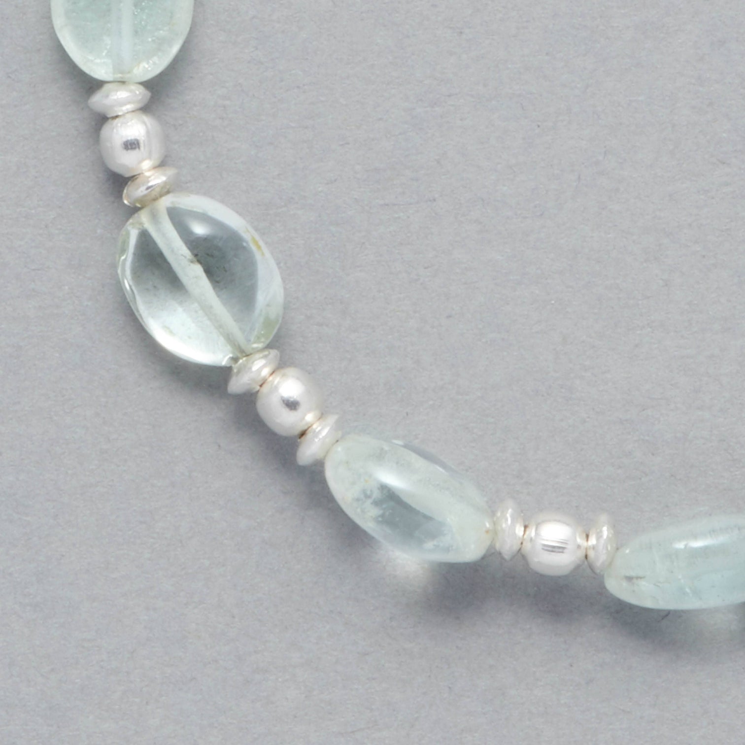 Detail shot of the Zoe Bracelet made with oval-shaped Aquamarine and Sterling Silver elements. 